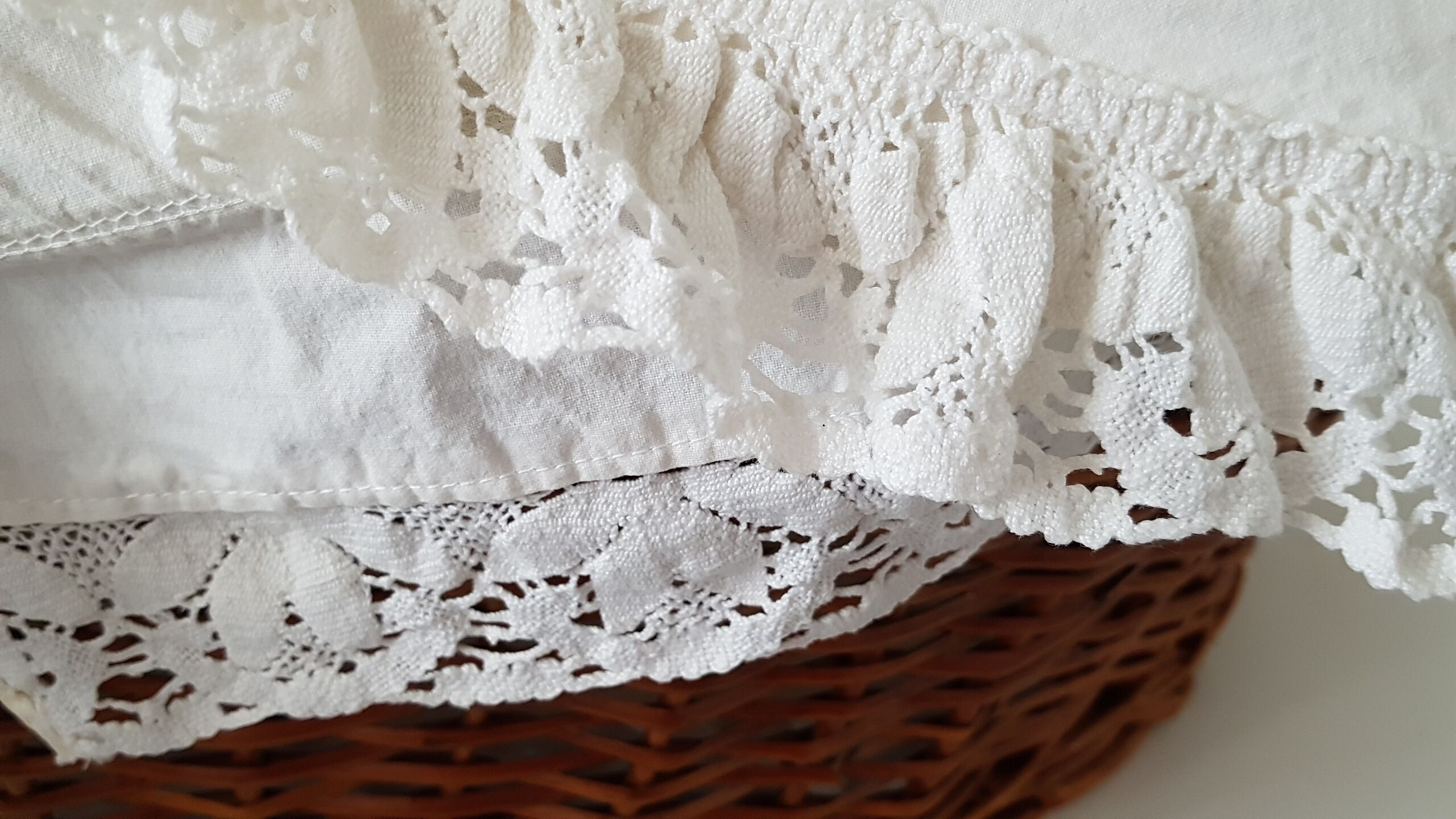 Old rattan bassinet and bedding