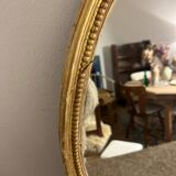 Old golden oval mirror