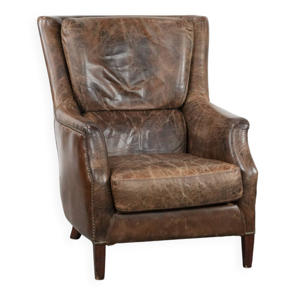Fauteuil en cuir de vache vintage très confortable avec de belles couleurs.