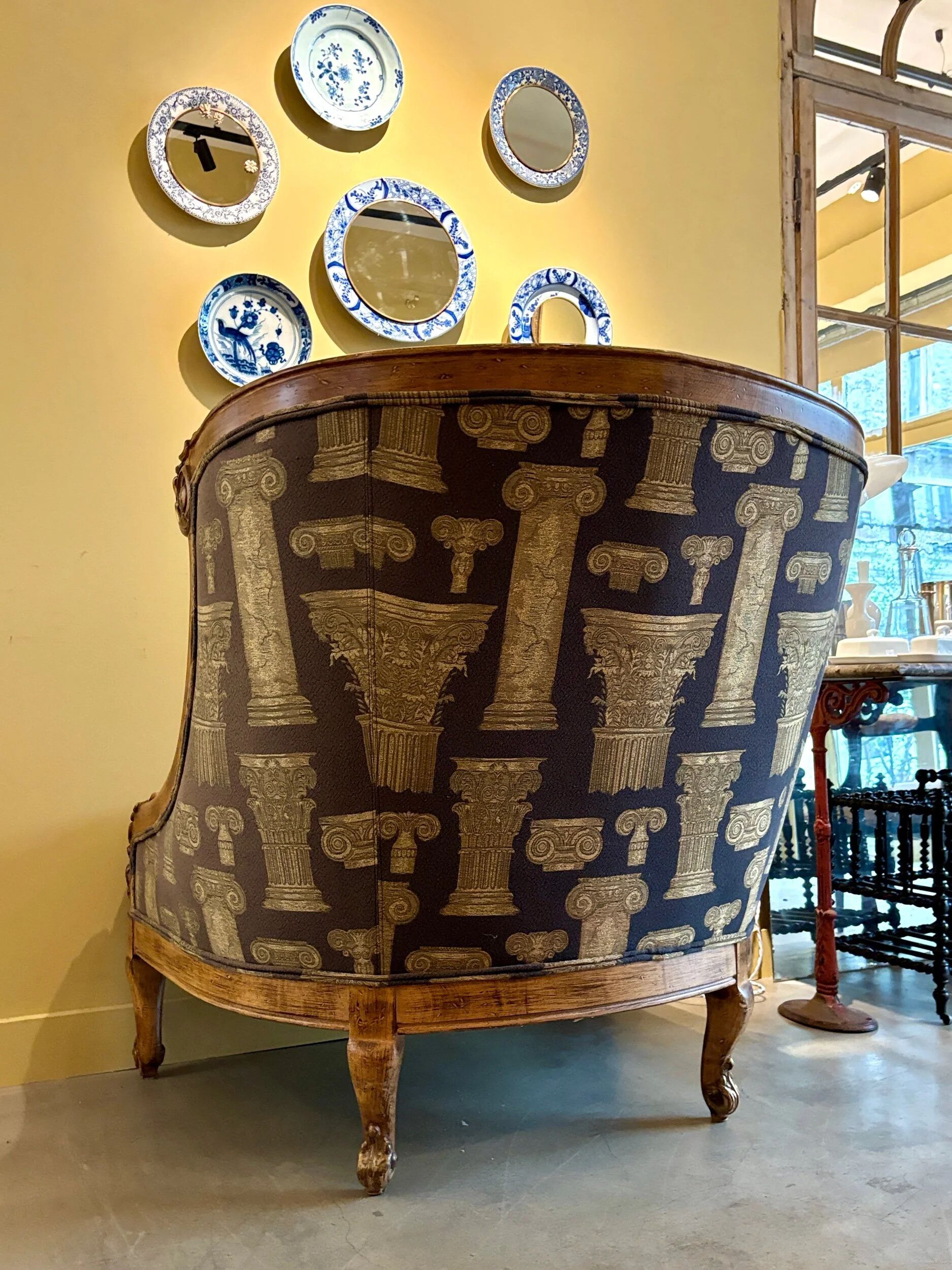 Armchair in a wooden confessional style with black and beige cotton.