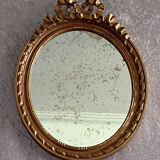 Oval mirror in carved and gilded wood in Louis XVI style