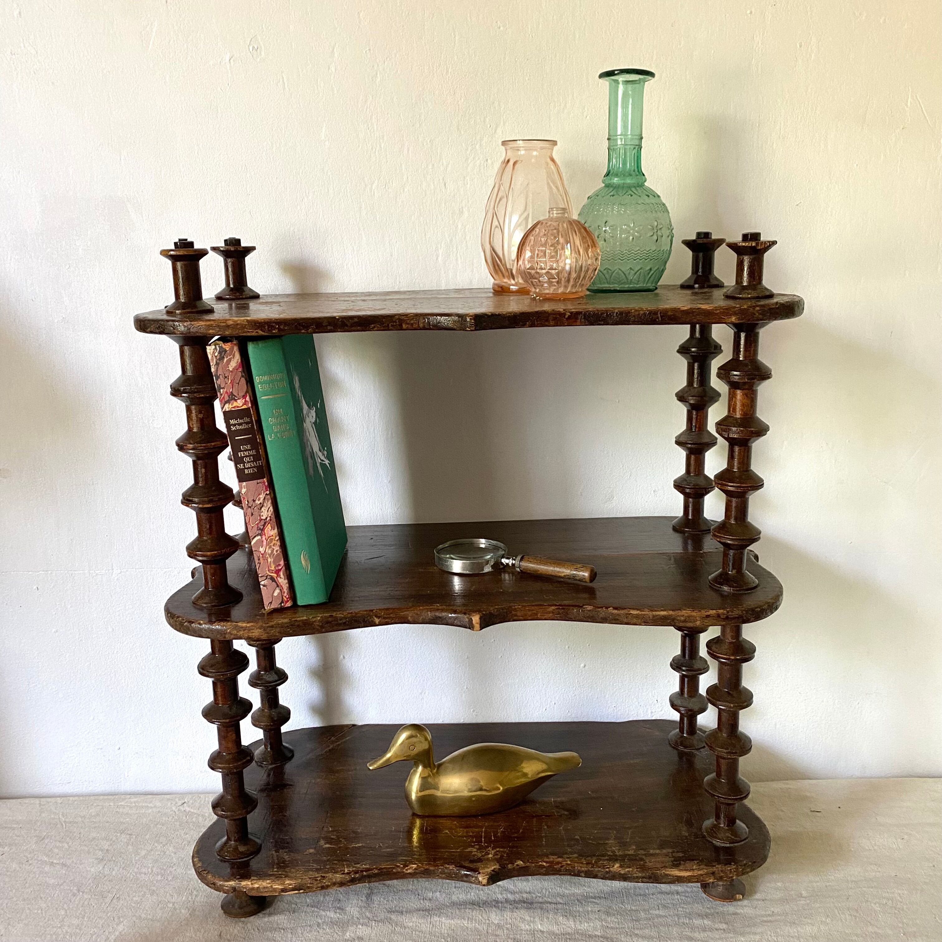 Old shelf in turned wood like reels