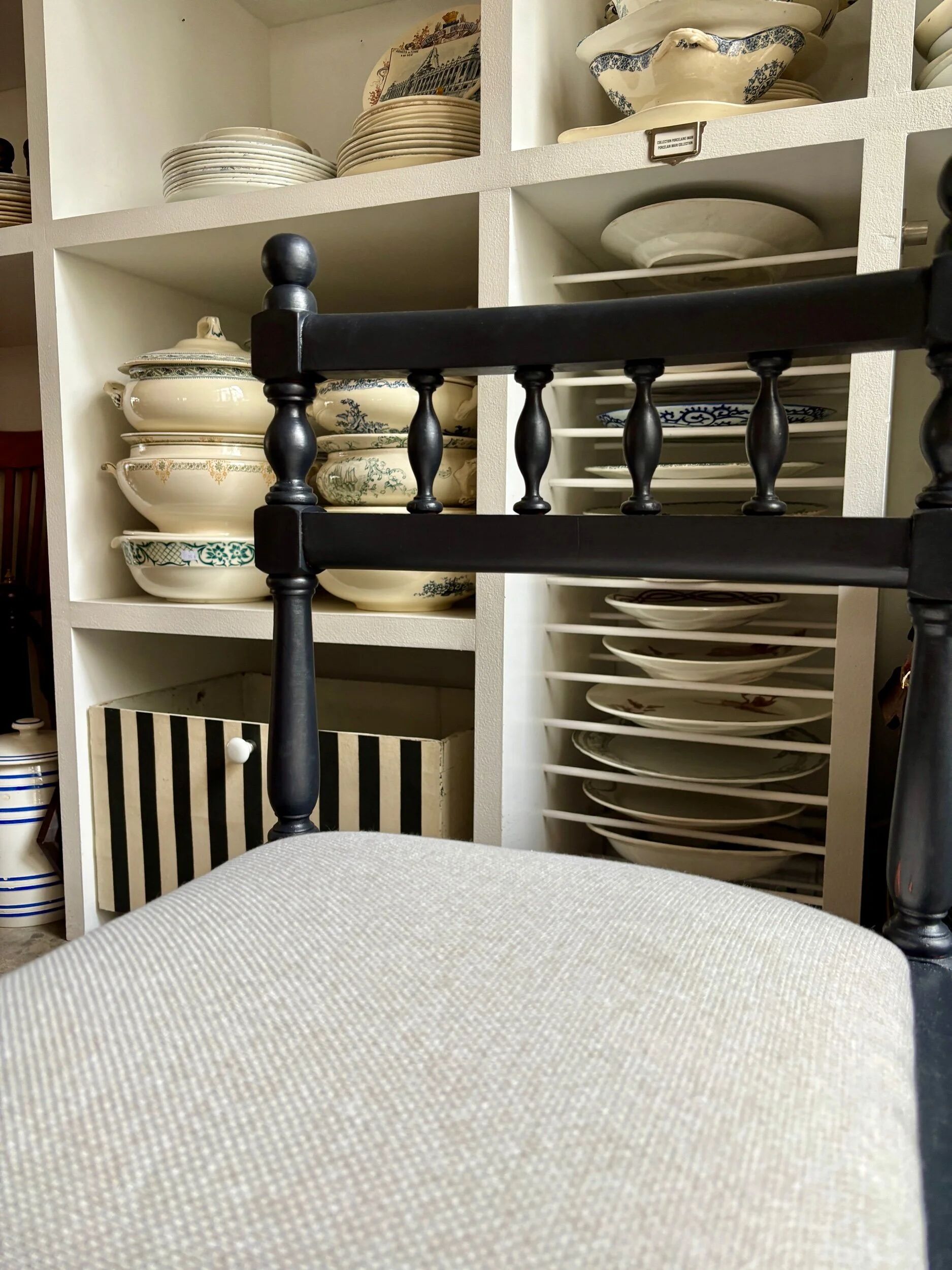 Black turned wooden chair and ivory cotton.