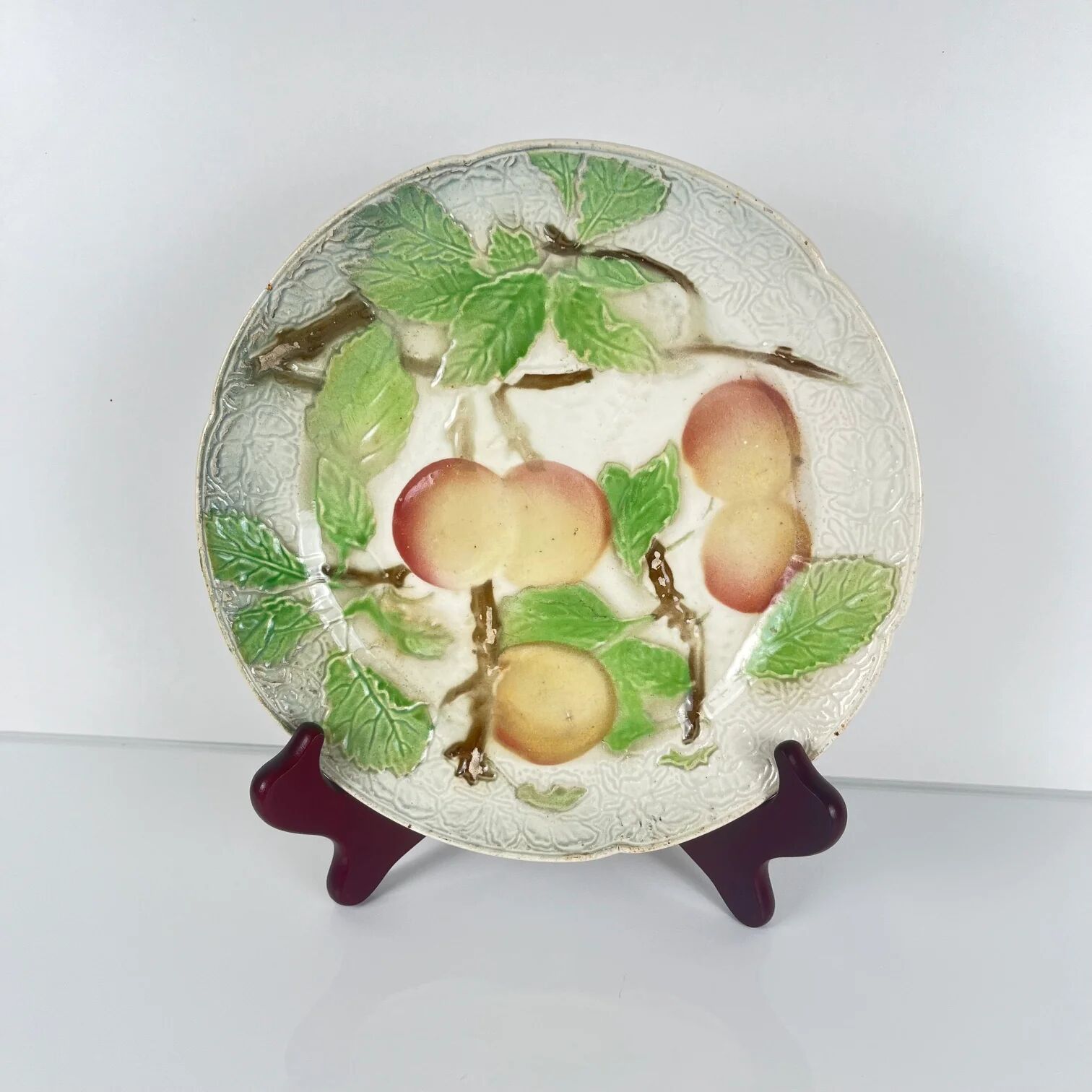Set of 4 plates KG St Clément barbotine fruit (cherry, mirabelle, grape, pear), late 19th-early 20th century.
