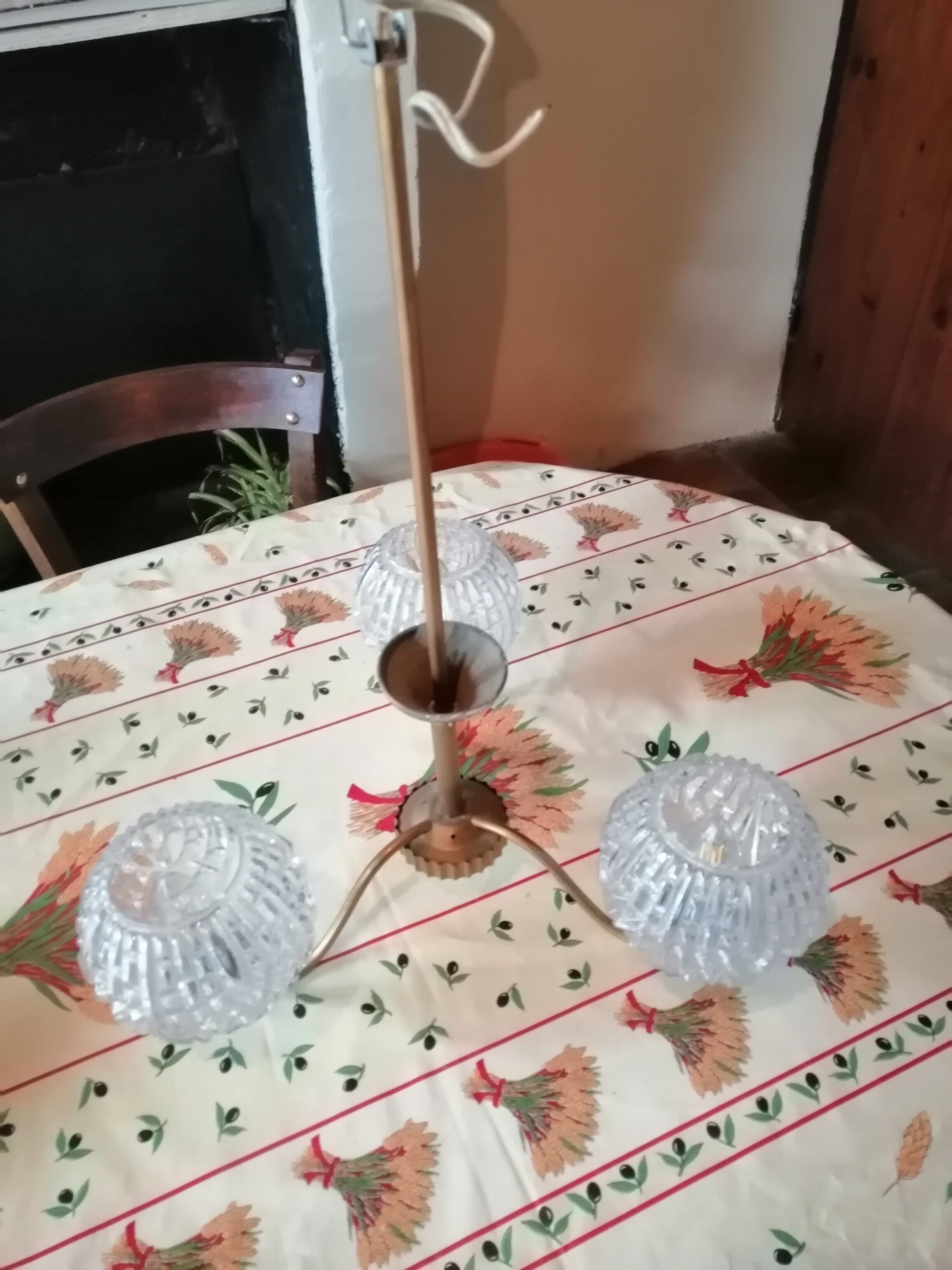 antique chandelier has 3 globes