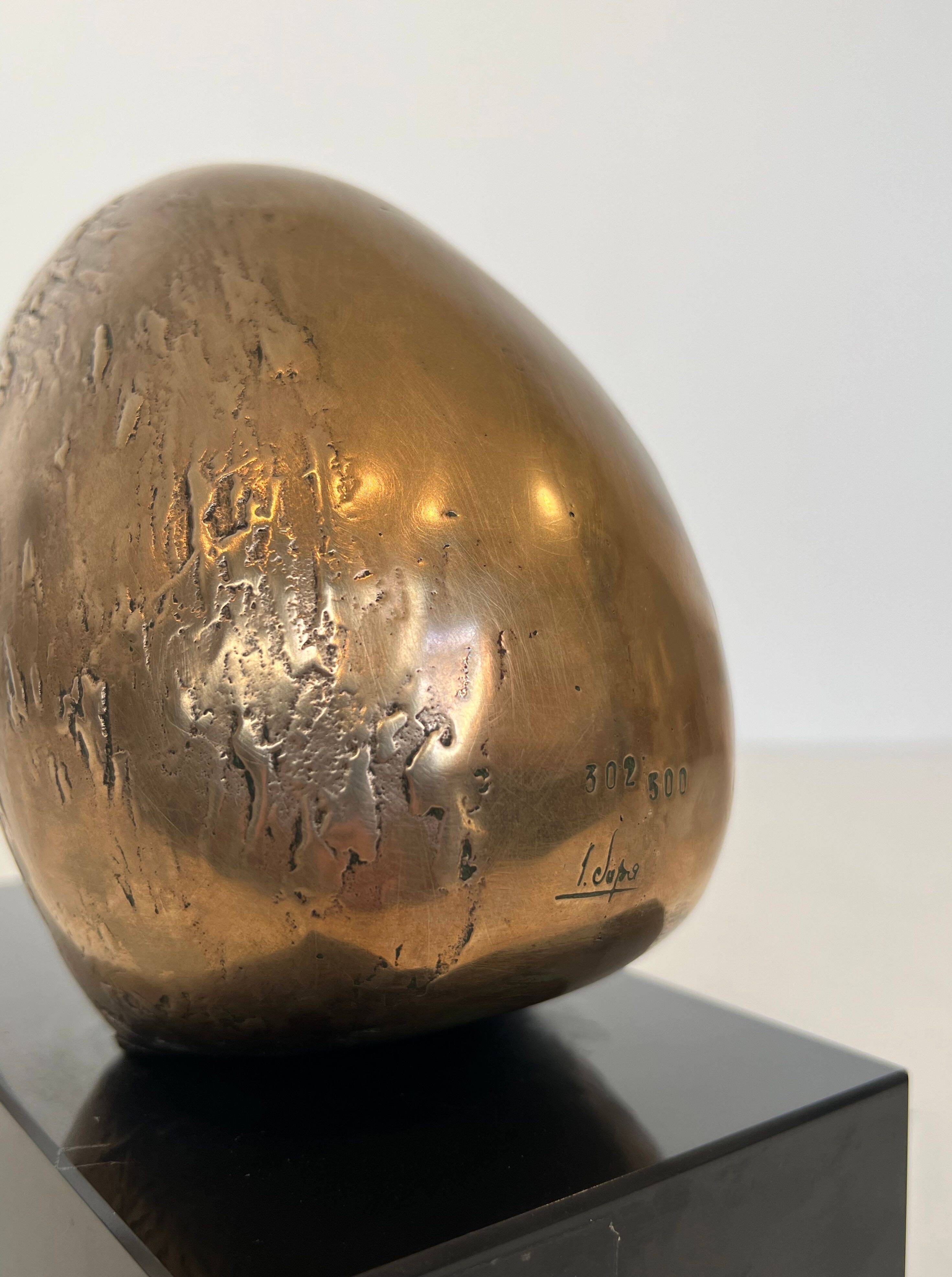 Bronze sculpture representing a stylised bird on a black marble base, signed and numbered.