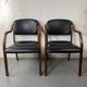 Paire de fauteuils en cuir et bois