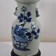 China. Porcelain mallet vase with blue and white phoenix decoration on a rock.