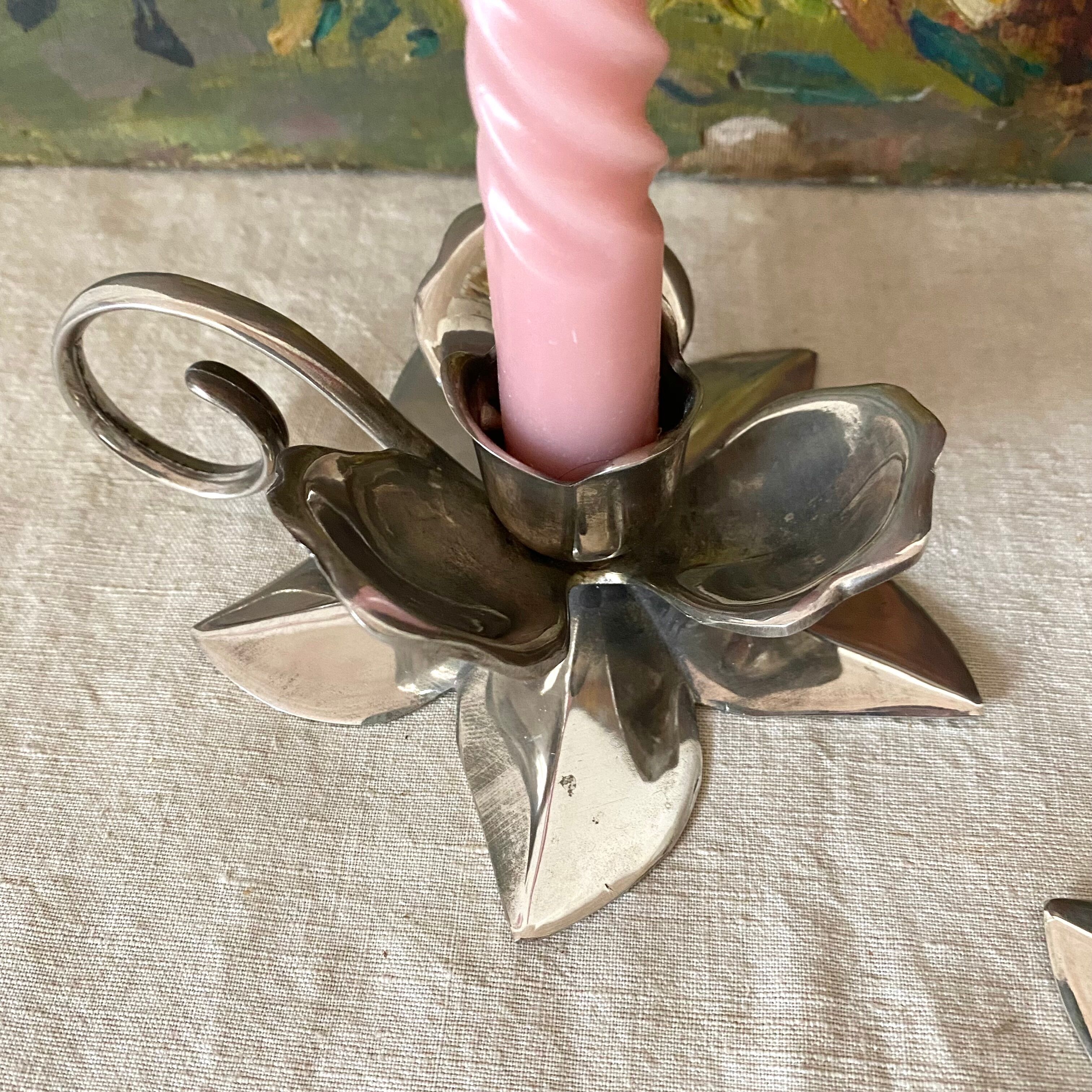 Pair of silver metal flower candle holders