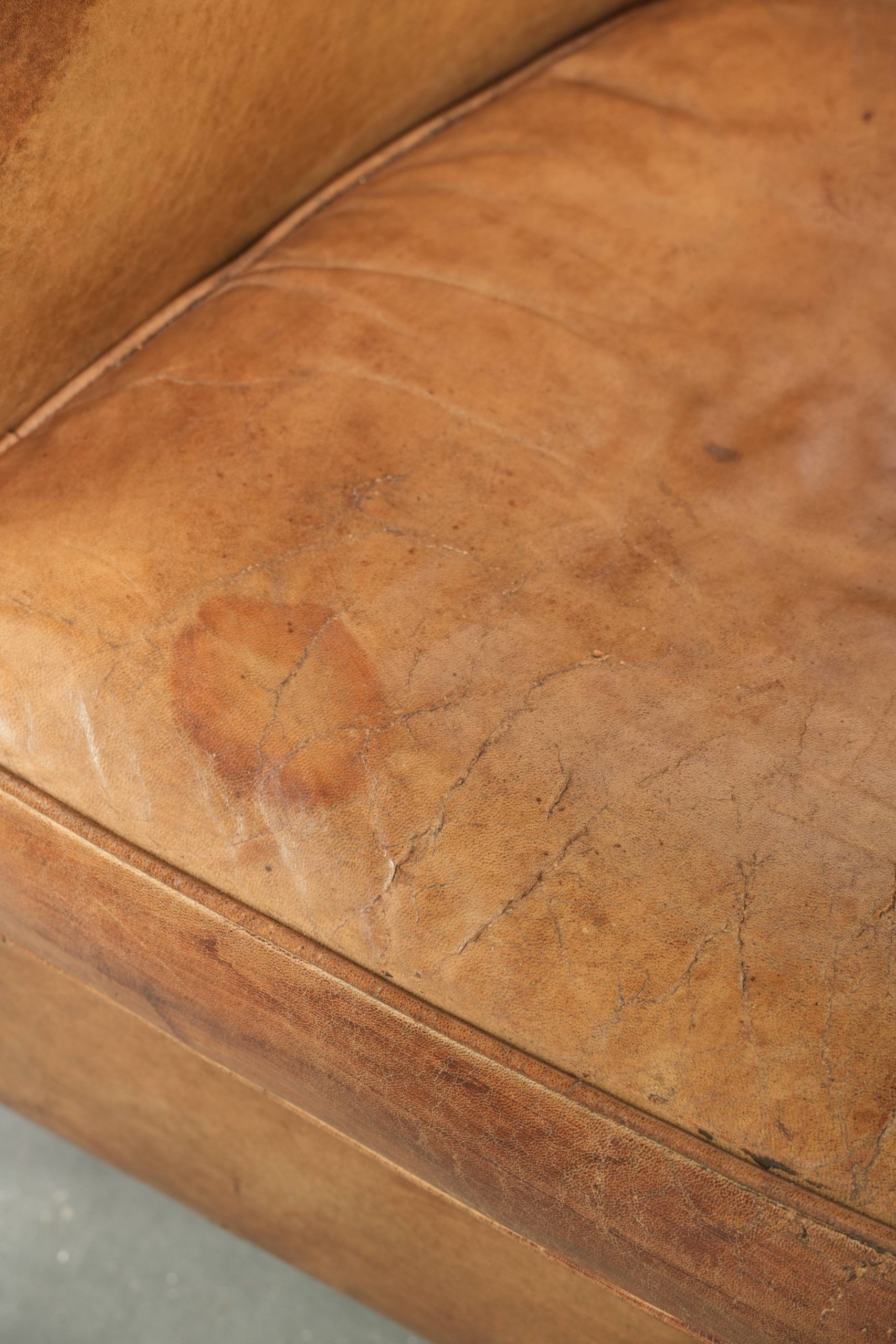 Vintage sheepskin club armchair finished with decorative nails