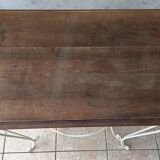 Wrought iron table with a walnut top.