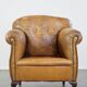 Fauteuil ancien en cuir de mouton