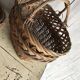 Set of 2 brown wicker baskets from the 1960s — decorative weaving and double handles.