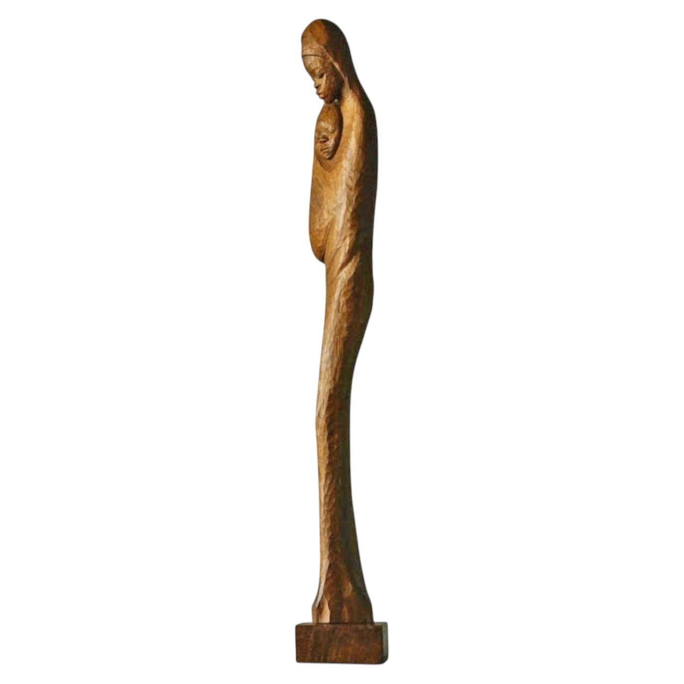Sculpture of a woman and child in hand-carved wood, mid-20th century.
