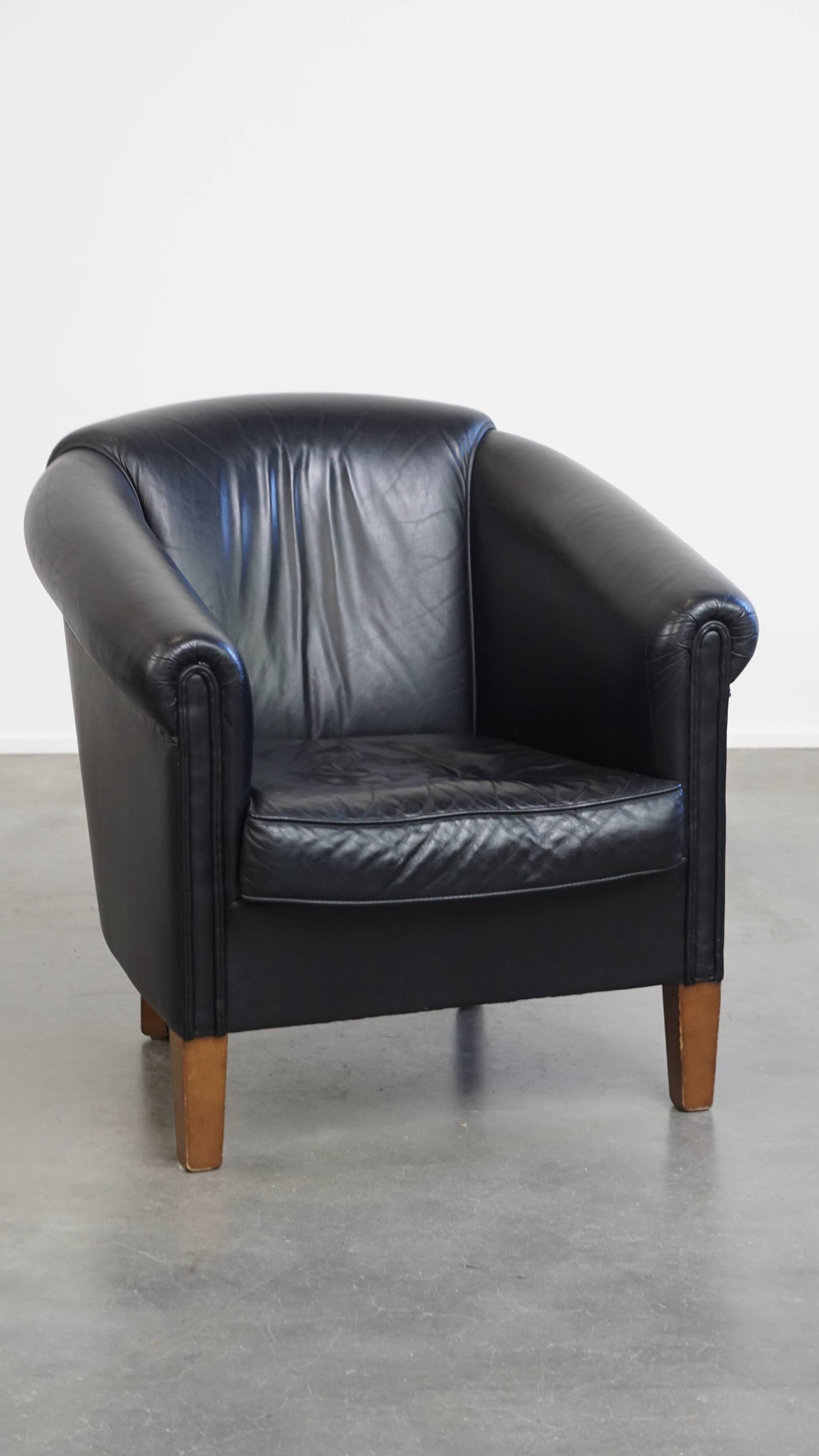 Black cowhide club chair in English style with a great luxurious design