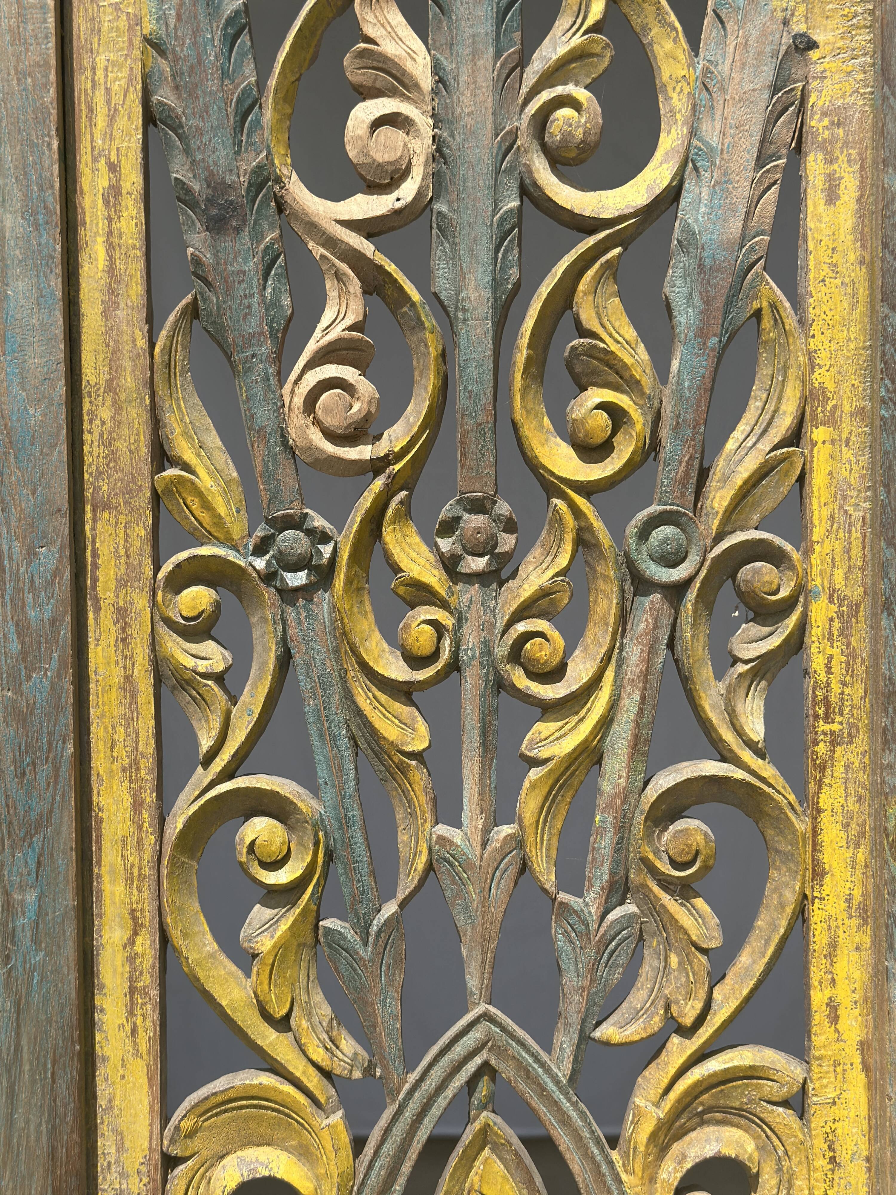 Rectangular Indonesian construction element with blue and yellow plant in carved wood