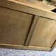 Antique carved wooden dressing table with marble and tilting oval mirror.