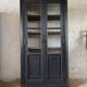 Aged patinated black display cabinet