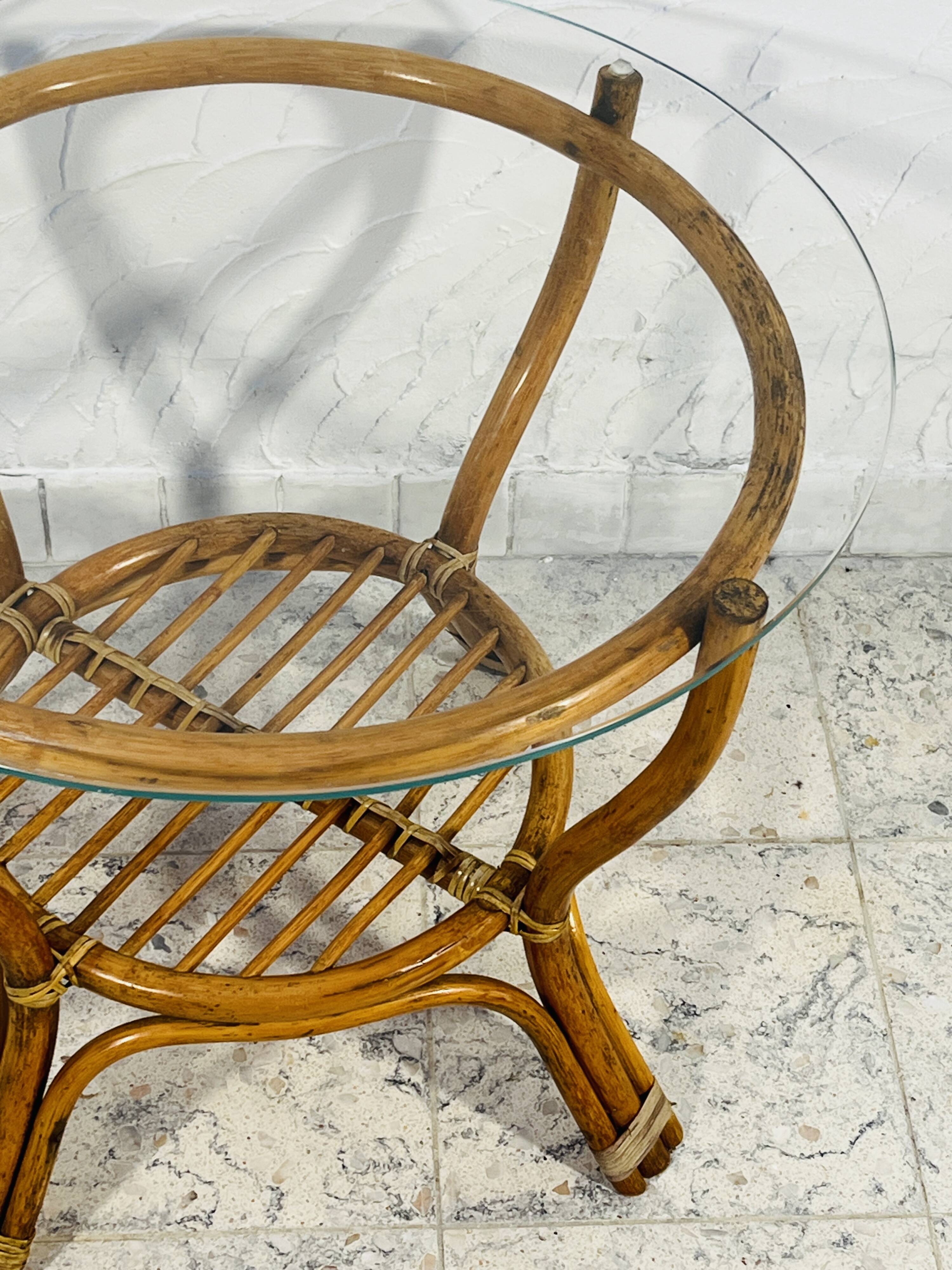 Vintage rattan coffee table with glass top from the 1970s.