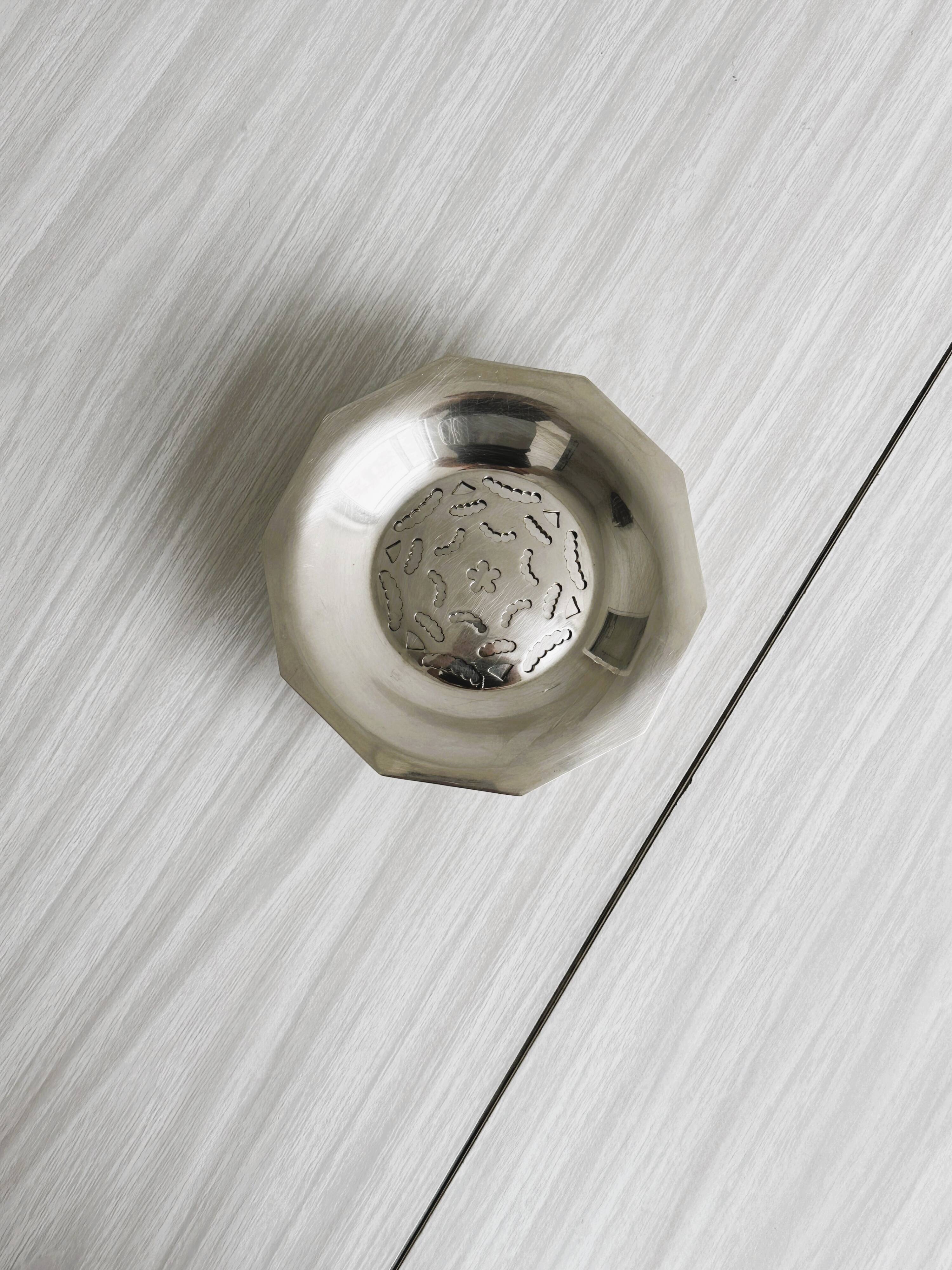 Antique butter dish in shiny metal