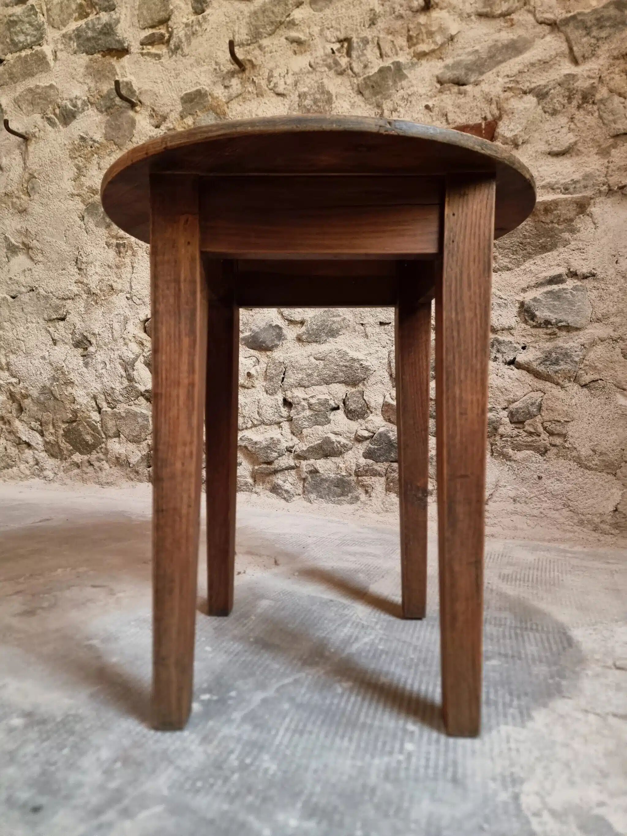 Antique round side table with oak legs and a pine top, circa 1900.