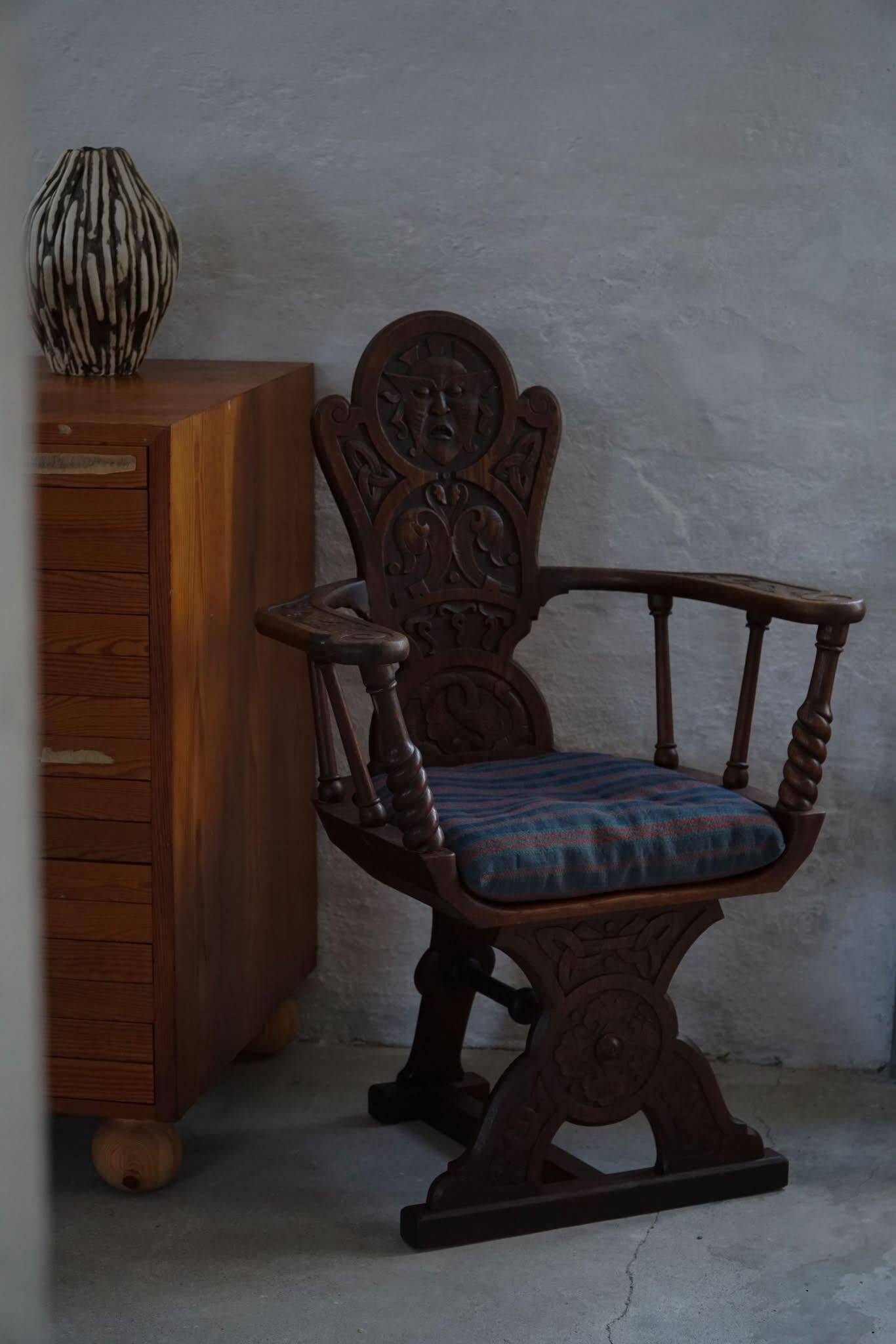 Scandinavian armchair in solid oak with cushion, folk art, early 19th century.