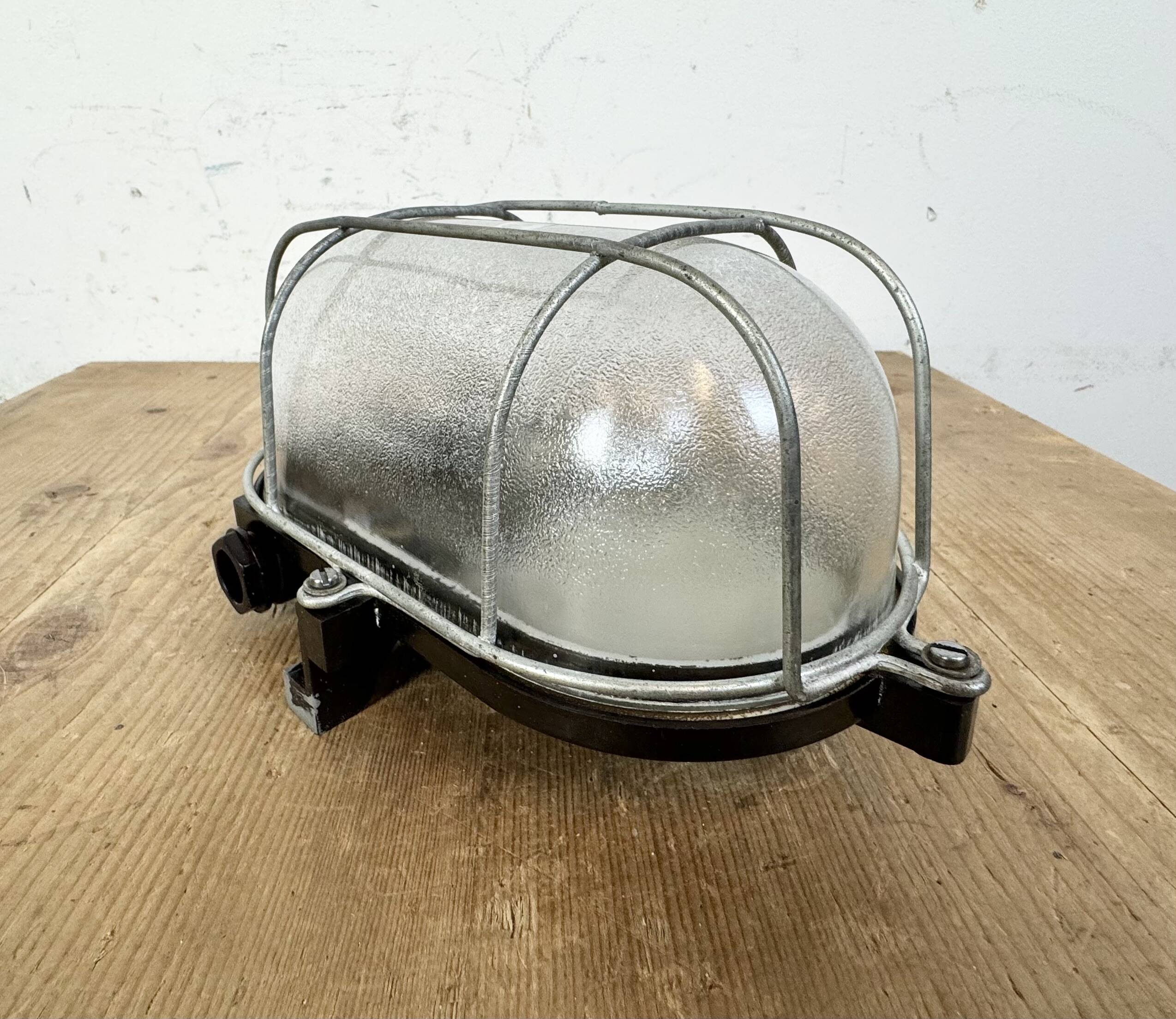 Industrial brown bakelite wall light with frosted glass, 1960s