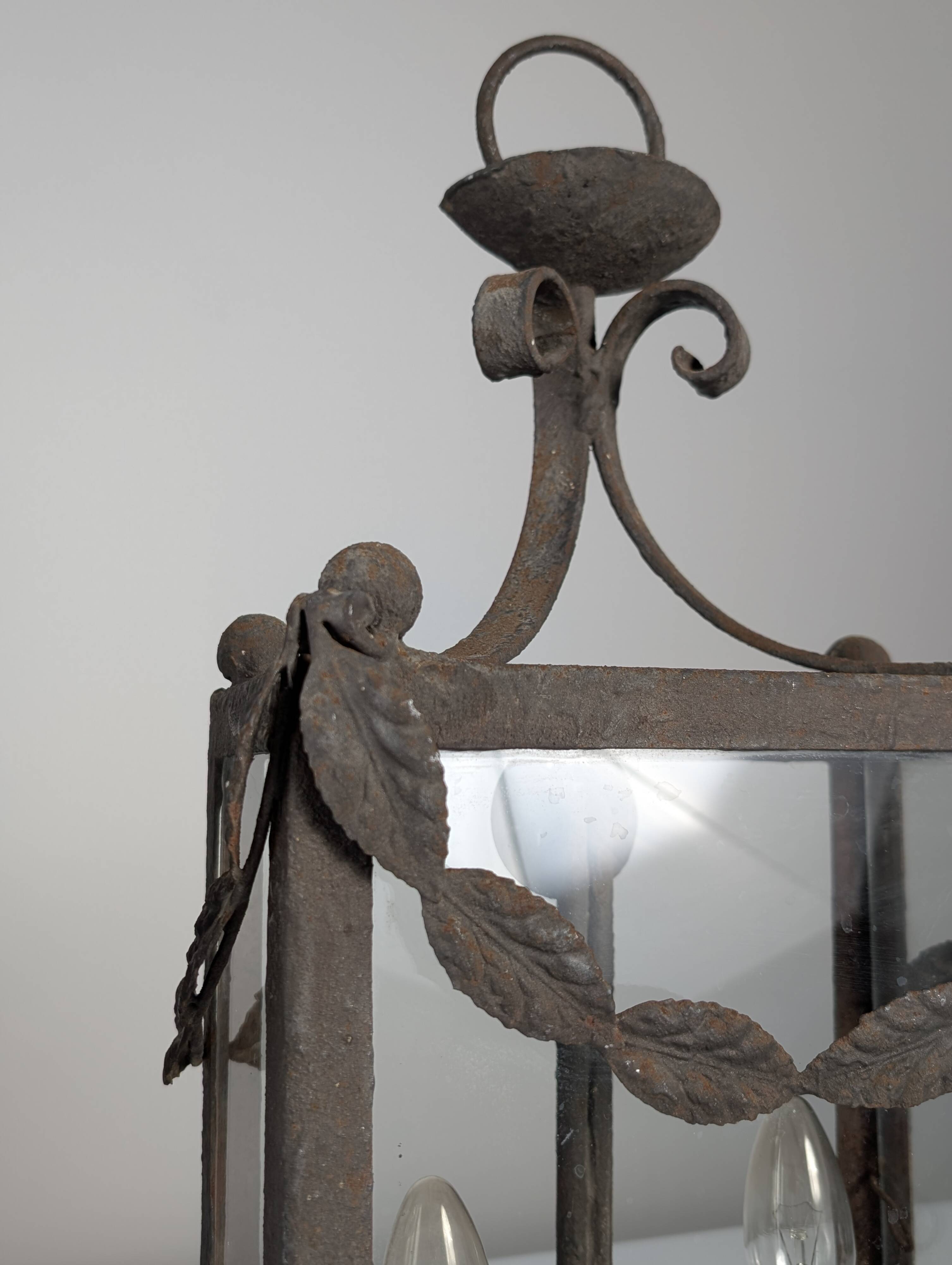Wrought iron lantern with glass panels, leaf motifs