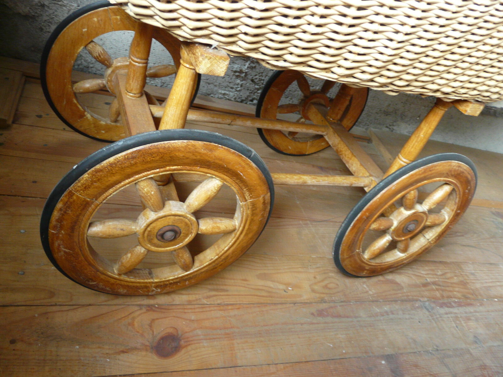 Old wooden cradle and wicker on wheels
