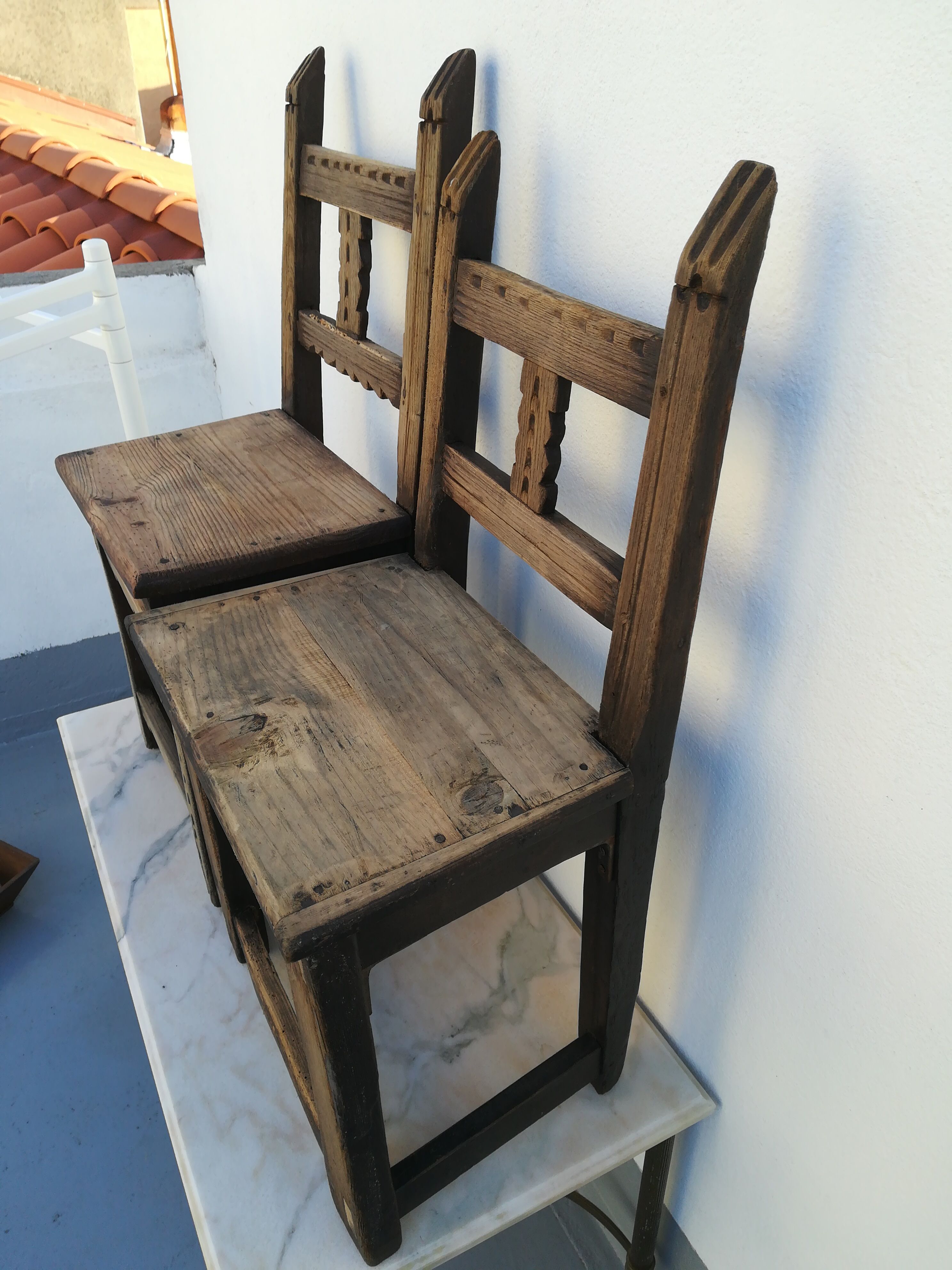 Pair of ethnic crude wooden chairs