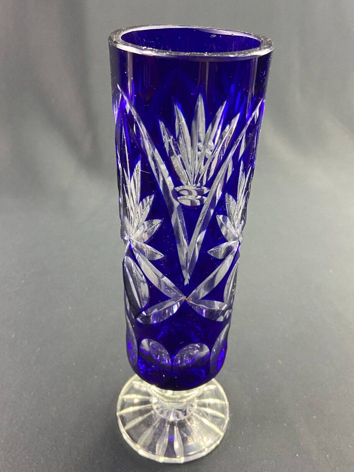 Tubular vase on a pedestal in cut blue Bohemian crystal.