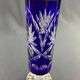 Tubular vase on a pedestal in cut blue Bohemian crystal.