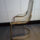 Tubular metal chair covered with gilding