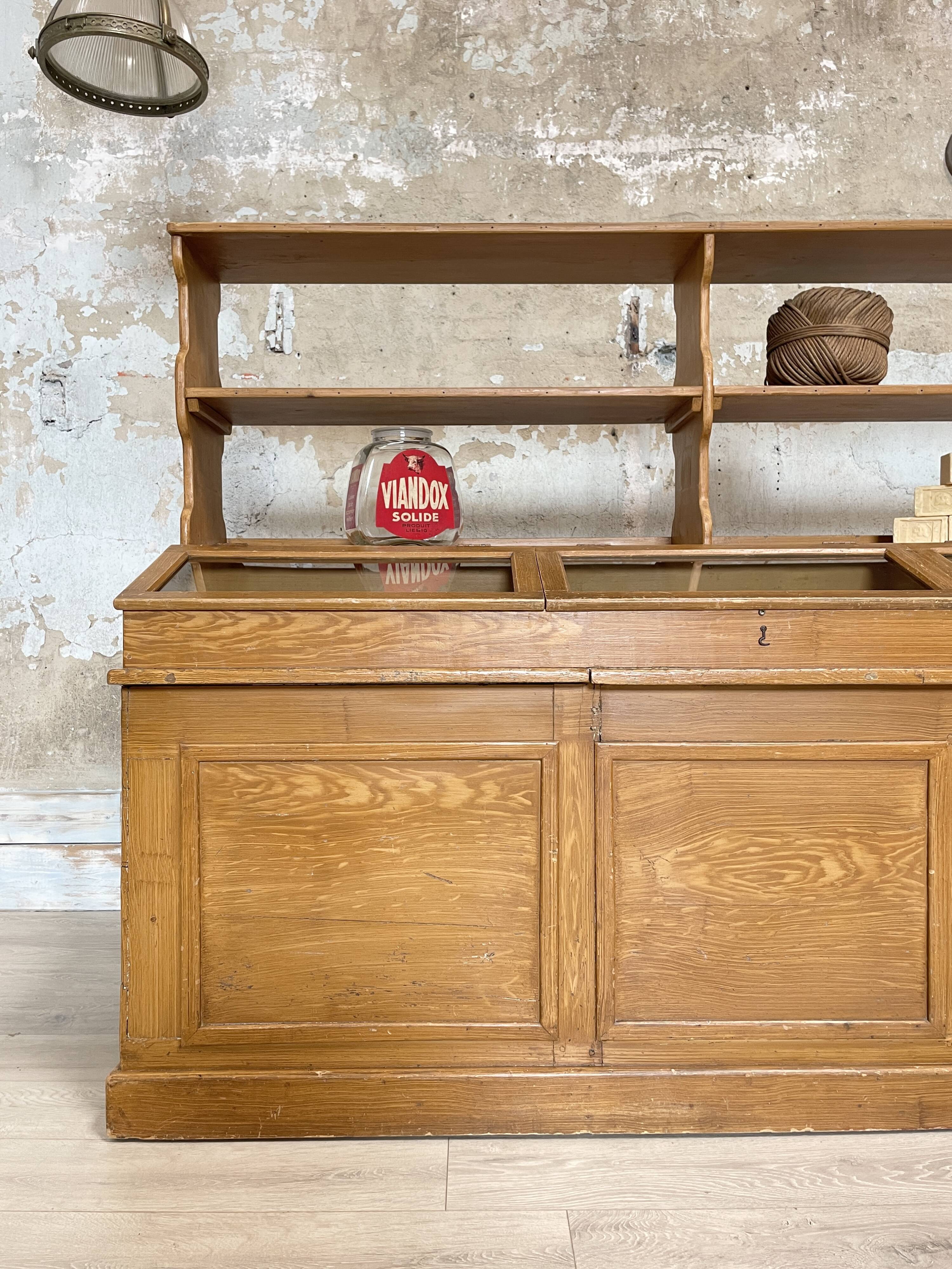 Wooden hardware cabinet painted with wood effect, circa 1940.