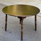 Extendable round table in solid wood with a dark oak satin finish.