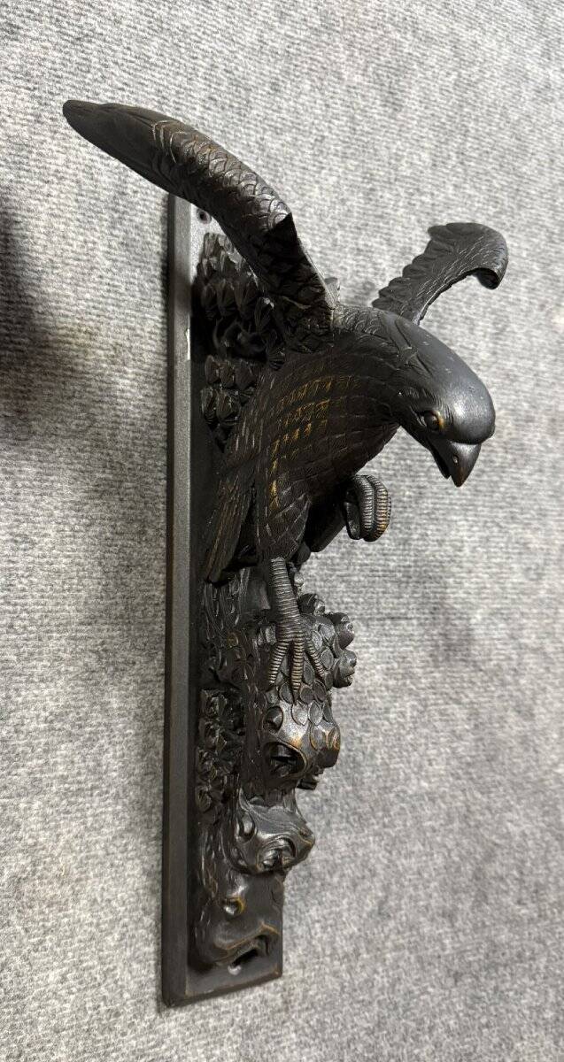 Rare pair of patinated wooden wall consoles, featuring two eagles with outstretched wings.