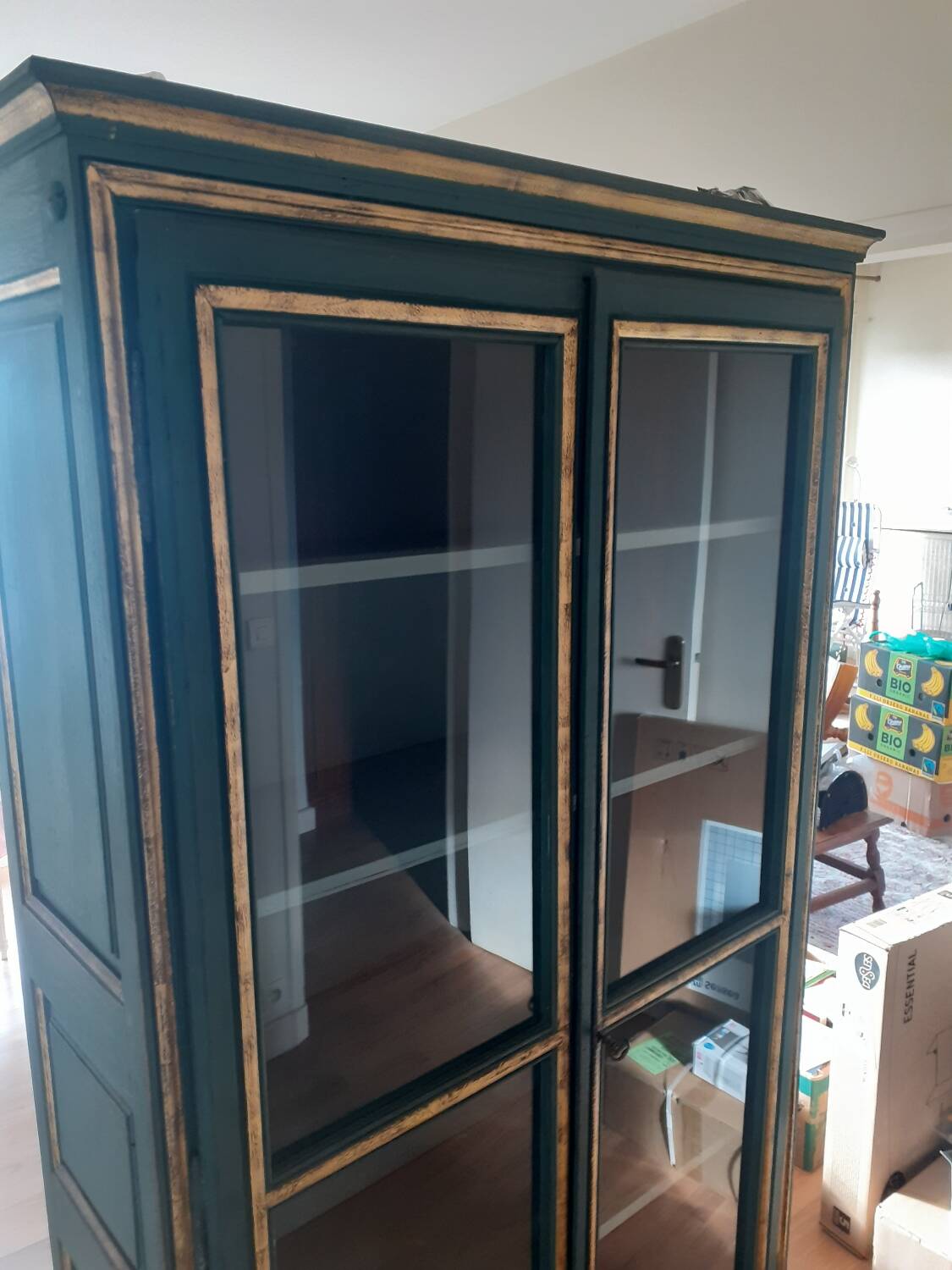 Glass-fronted cabinet in weathered green wood