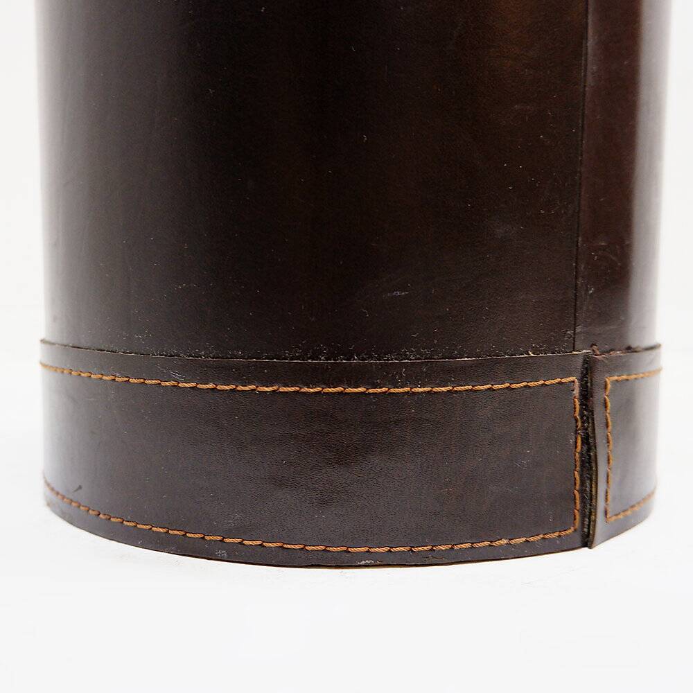 Brown leather wastepaper basket with decorative gold metal buckle.
