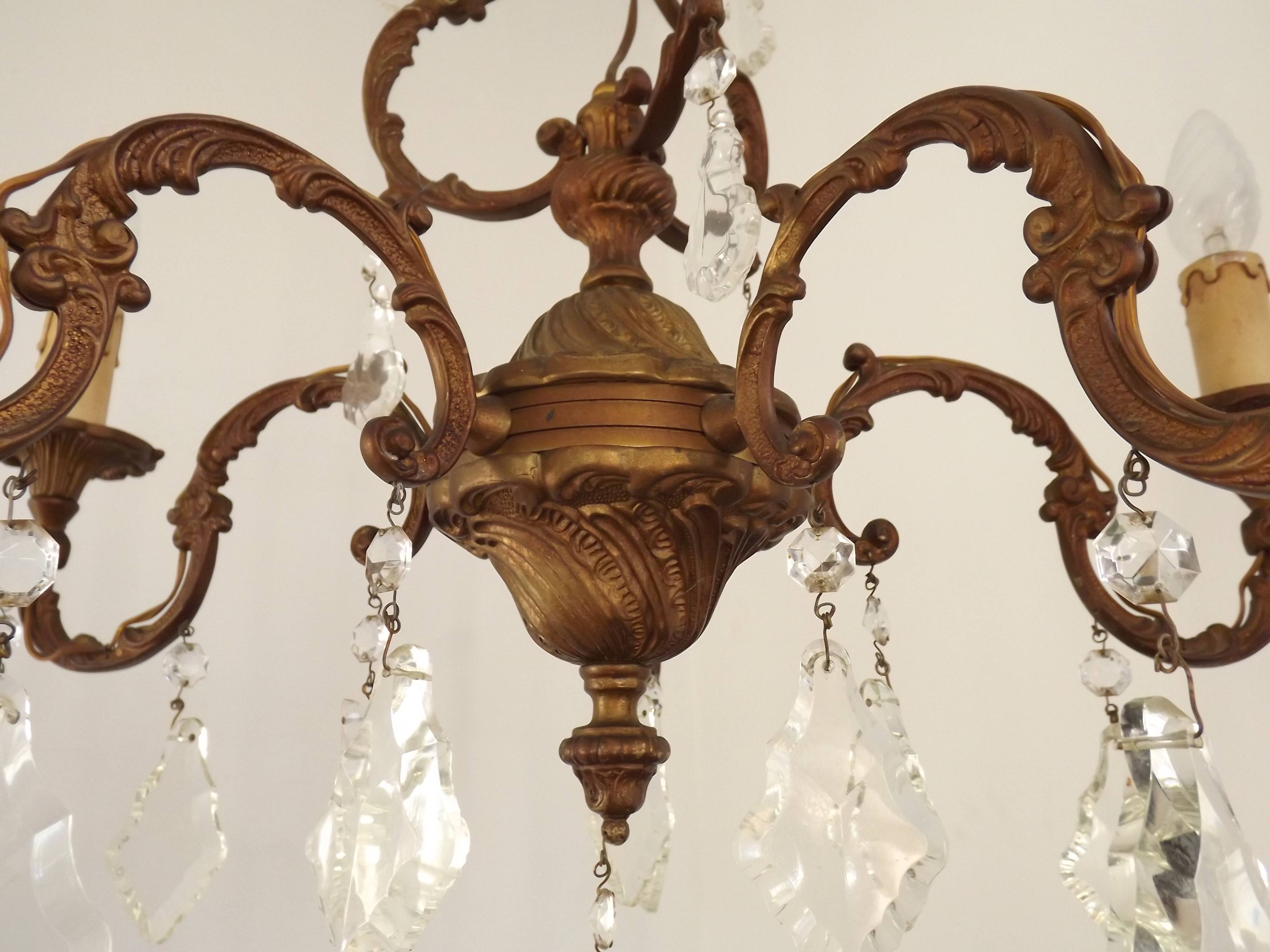 Antique French bronze chandelier with 6 lights and matching crystals.