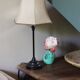 Table lamp with a patinated base and vintage woven shade.
