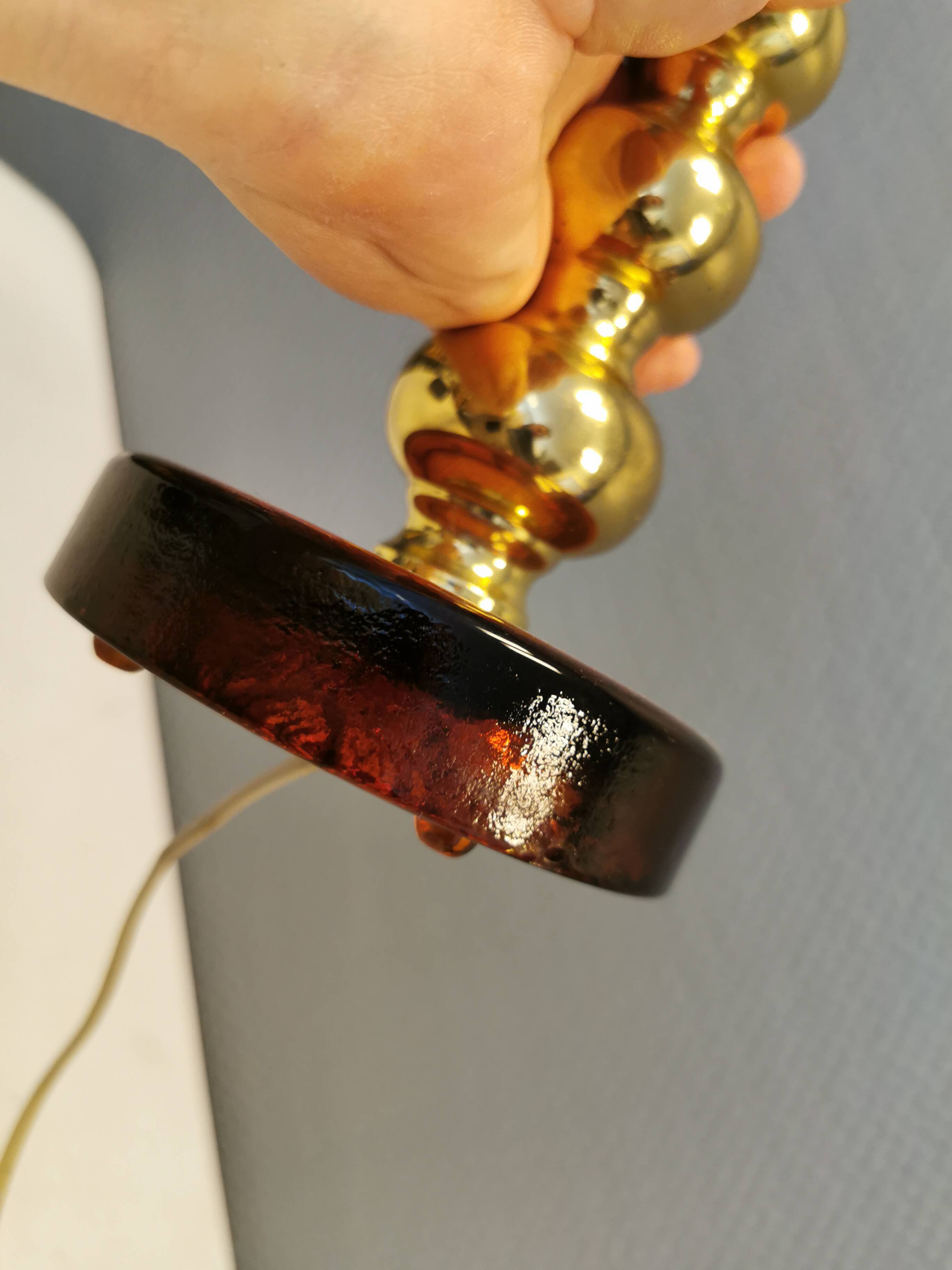 Table lamp from Danish Vitrika in brass, amber colored hard pressed glass, with a shade holder.