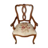 Upholsterer armchair covered with a publisher fabric with a central floral pattern
