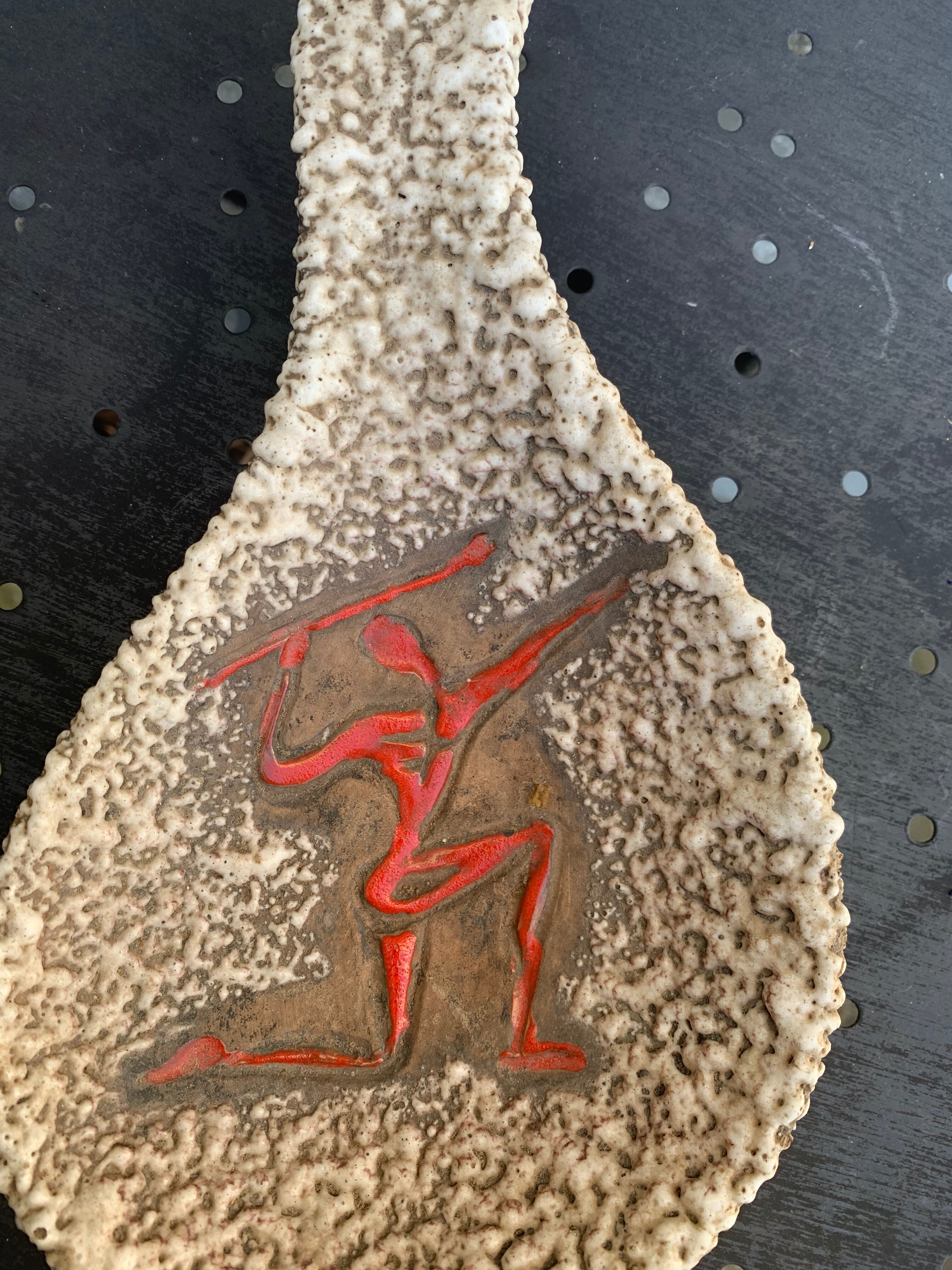 Glassed ceramic cut enamelled prehistoric warrior motif vintage red 1950