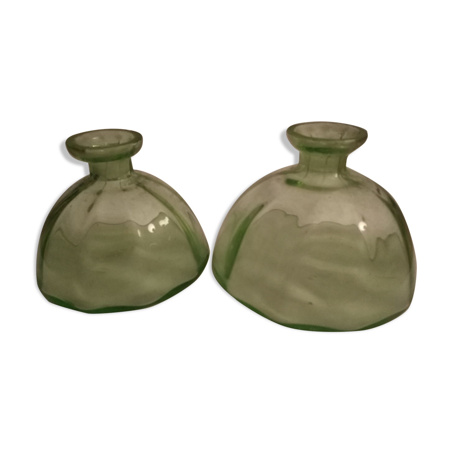 Two bottles in glass, (certainly), surroundings of the 1930s