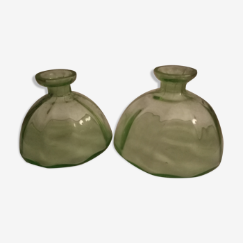 Two bottles in glass, (certainly), surroundings of the 1930s