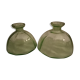 Two bottles in glass, (certainly), surroundings of the 1930s
