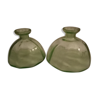 Two bottles in glass, (certainly), surroundings of the 1930s