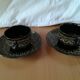 Black cups and saucers with relief decoration