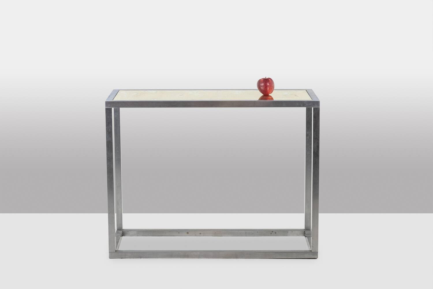 Maison Jansen. Console in brushed aluminium and verre églomisé top.