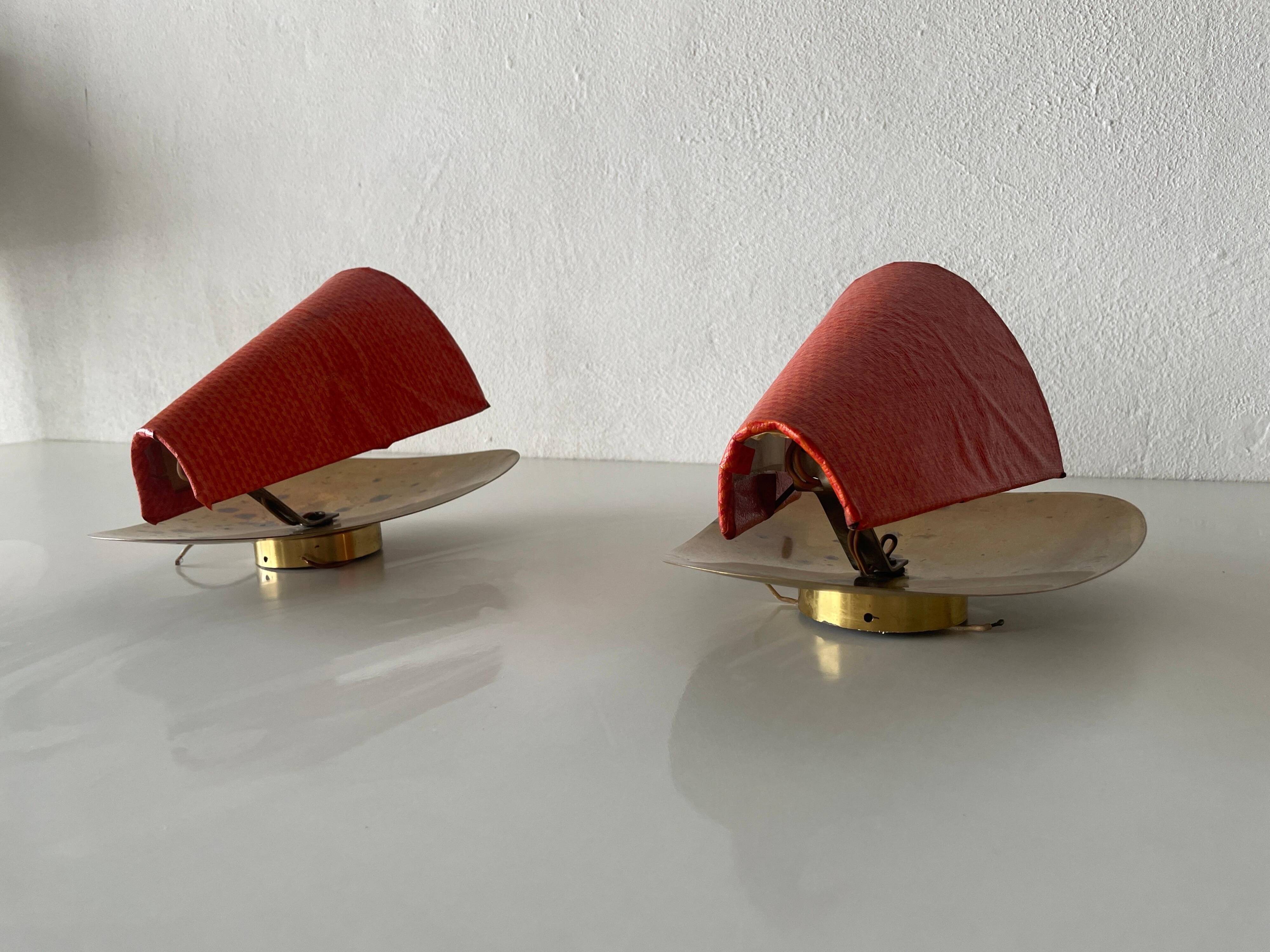 Pair of orange plexiglass and curved brass wall lights, 1950s, Germany